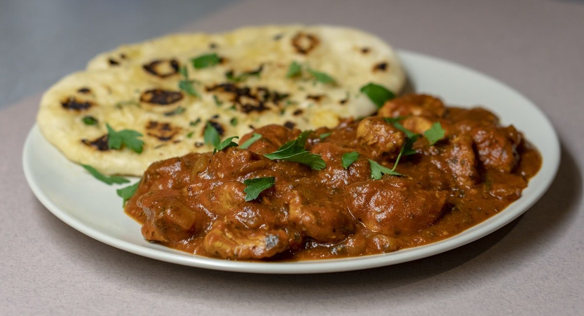 Butter chicken curry served with fresh naan at Leduc Meat & Grill in Leduc, Alberta