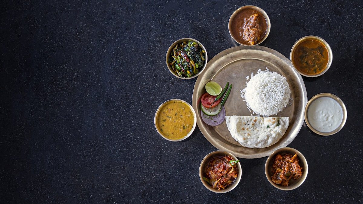 Indian thali lunch combo with rice, naan, dal and curries — lunch specials at Leduc Meat & Grill in Leduc, Alberta