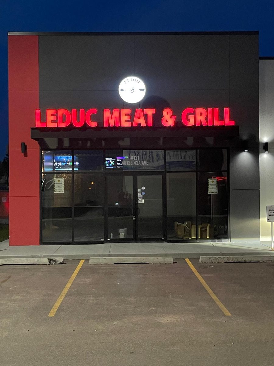 Leduc Meat & Grill storefront lit up at night at #121, 4812E 43A Avenue in Leduc, Alberta